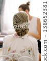 Intimate Scene Showing Bride Preparing With Detailed Braided Chignon And Subtle Lighting 138652381