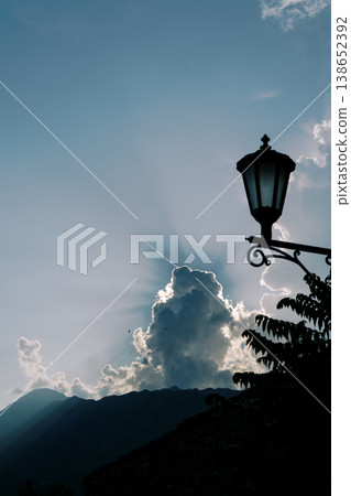 Skyward Illuminated Scene. Serene Outdoor Landscape With Majestic Mountain And Glowing Clouds 138652392