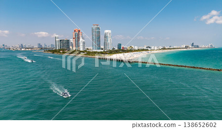Aerial view of boats on turquoise waters in Miami. Yacht retreat in Miami. Oceanfront cityscape with sailing vessels in Miami. Relaxing vacation in Miami. Beautiful sunset over the coastal city. 138652602