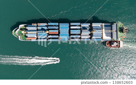 Cargo ship vessel leaving port. Container ship. Export and import. Cargo business. Shipping logistics. Cargo ship with container, aerial top view. Freight container on cargo vessel. Sea transportation Cargo ship vessel leaving port. Container ship. Export and import. Cargo business. Shipping logistics. Cargo ship with container, aerial top view. Freight container on cargo vessel. Sea transportation 138652603