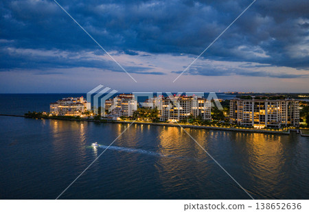 Aerial night view of Miami coastline. Twilight skyline above the Miami oceanfront. Miami Beach waterfront glowing after sunset. Famous Miami Beach from above. Aerial night view of Miami coastline. Twilight skyline above the Miami oceanfront. Miami Beach waterfront glowing after sunset. Famous Miami Beach from above. 138652636