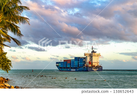 Miami, Florida, USA - December 14, 2024: Cargo Seaboard blue ship services with container, aerial sunset view. Freight container on cargo vessel. Cargo ship vessel. Miami port. Container ship 138652643