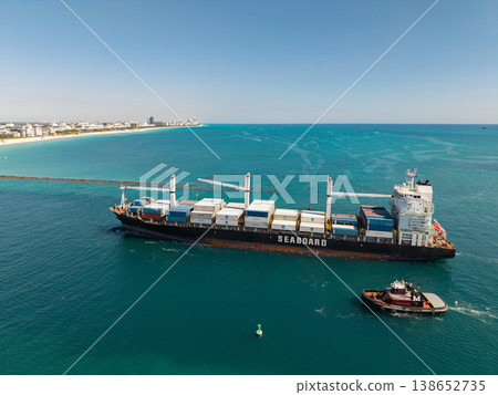 Miami, Florida, USA - March 20, 2025: Miami sea port. Container Monrovia ship. Cargo Seaboard Explorer container ship, aerial view. Freight container cargo vessel and tugboat. Cargo ship vessel 138652735