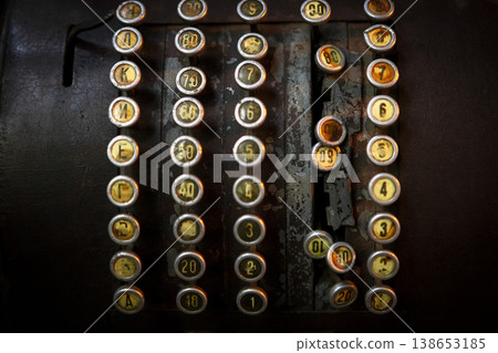 Classic black cash register elegantly displayed on a rustic wooden table in a cozy caf setting. Classic black cash register elegantly displayed on a rustic wooden table in a cozy caf setting. 138653185
