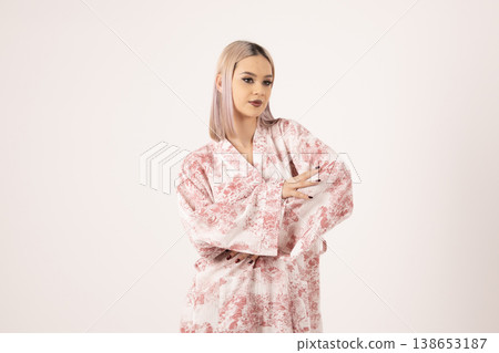 Elegant woman wearing patterned silk robe posing in studio Elegant woman wearing patterned silk robe posing in studio 138653187