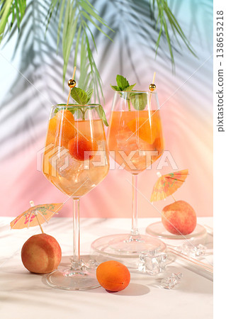 Modern still life with fruits. Royal lemonade cocktail with peach, apricot, mojito with tequila, gin, rum, ice and fresh mint, bar and party concept, restaurant and cafe advertising card Modern still life with fruits. Royal lemonade cocktail with peach, apricot, mojito with tequila, gin, rum, ice and fresh mint, bar and party concept, restaurant and cafe advertising card 138653218