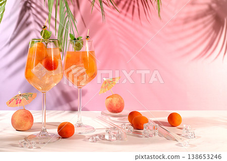 Modern still life with fruits. Royal lemonade cocktail with peach, apricot, mojito with tequila, gin, rum, ice and fresh mint, bar and party concept, restaurant and cafe advertising card Modern still life with fruits. Royal lemonade cocktail with peach, apricot, mojito with tequila, gin, rum, ice and fresh mint, bar and party concept, restaurant and cafe advertising card 138653246