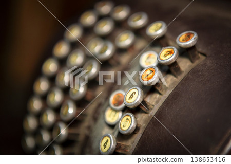 Classic black cash register elegantly displayed on a rustic wooden table in a cozy caf setting. 138653416