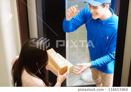 A man from Kumo Commercial delivering a small package. 138653968