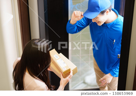 A man from Kumo Commercial delivering a small package. 138653969