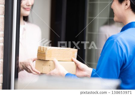 A man from Kumo Commercial delivering a small package. A man from Kumo Commercial delivering a small package. 138653971