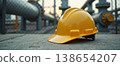 Yellow safety helmet on industrial pipeline at sunset 138654207