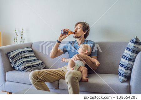 Stressed father sitting on couch holding baby and drinking beer at home. Exhausted parent struggling with responsibility and alcohol. Parenting stress, addiction and mental health concept 138654295