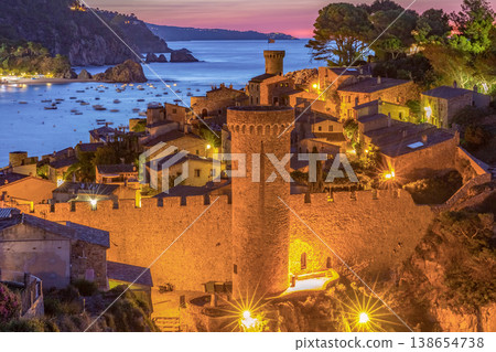 Night view of fortified old town and bay in Tossa de Mar, Spain Night view of fortified old town and bay in Tossa de Mar, Spain 138654738