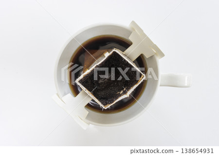A coffee cup from which coffee has been brewed using a drip bag. A coffee cup from which coffee has been brewed using a drip bag. 138654931