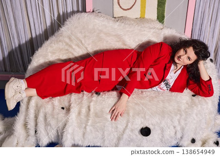 Intimate portrait of woman in red suit relaxing comfortably Intimate portrait of woman in red suit relaxing comfortably 138654949