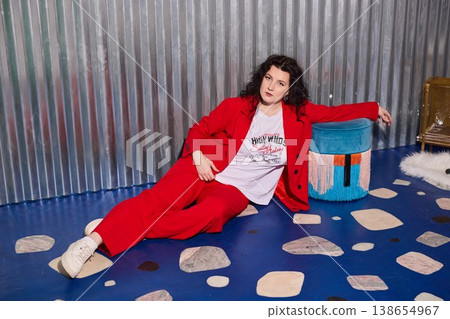Caucasian woman interior stylist in red suit with ottoman Caucasian woman interior stylist in red suit with ottoman 138654967