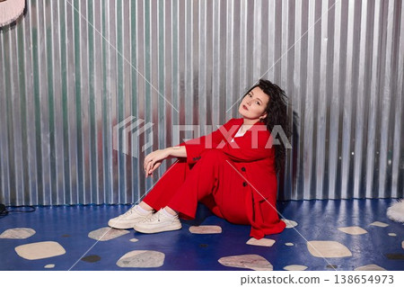 Confident woman in red with composed demeanor and friendly aura Confident woman in red with composed demeanor and friendly aura 138654973