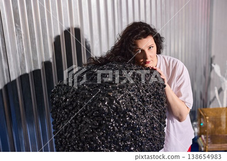 Woman studies sculpture. Figure examines textured metal art Woman studies sculpture. Figure examines textured metal art 138654983