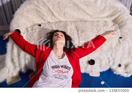 Woman in scarlet attire moment captured relaxingly on sofa Woman in scarlet attire moment captured relaxingly on sofa 138655009