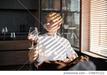 Young man inspecting wine aroma in contemporary loft environment 138655122