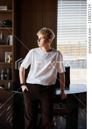 Young Caucasian man seated at desk contemplating new project ideas 138655124