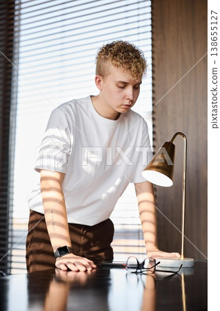 Man cautiously adjusting lamp fixture with precise care Man cautiously adjusting lamp fixture with precise care 138655127
