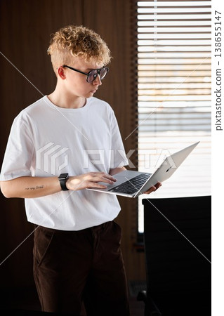 Teenager attentively examining notes in comfortable study environment Teenager attentively examining notes in comfortable study environment 138655147