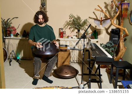 Portrait of musician relaxing amidst studio tools and equipment 138655155