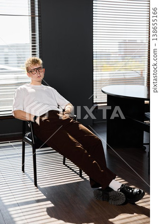 Informal male worker enjoying sunny ambiance in contemporary office Informal male worker enjoying sunny ambiance in contemporary office 138655166