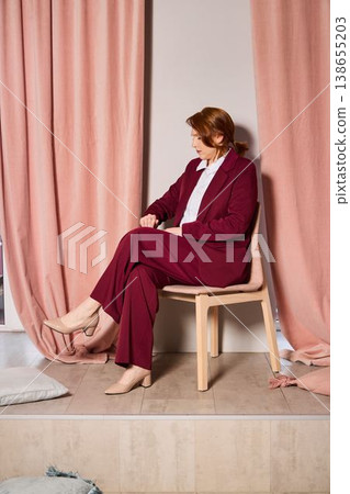 Reflective mentor portrait. Redheaded woman in contemplative pose Reflective mentor portrait. Redheaded woman in contemplative pose 138655203