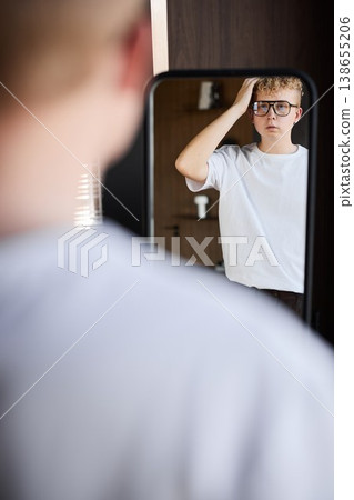 Young caucasian male rehearsing lines in mirror for audition Young caucasian male rehearsing lines in mirror for audition 138655206