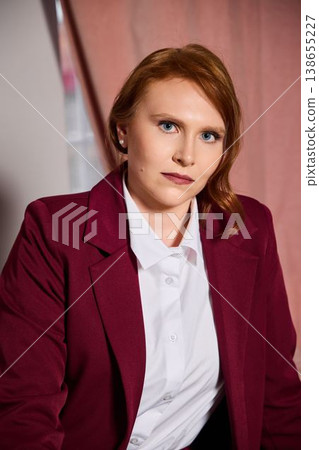 Intense facial portrayal of professional redhead woman in studio setting Intense facial portrayal of professional redhead woman in studio setting 138655227