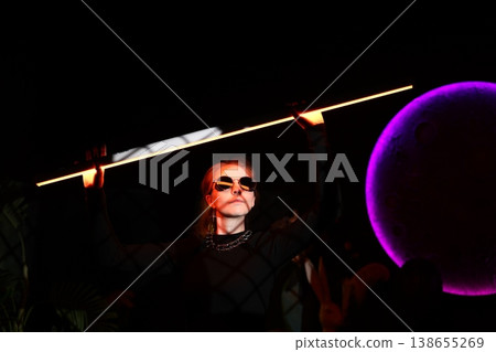Sleek figure with fiery hair and purple halo in ritual setting Sleek figure with fiery hair and purple halo in ritual setting 138655269