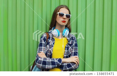 young woman listening to music, girl with headphones 138655471