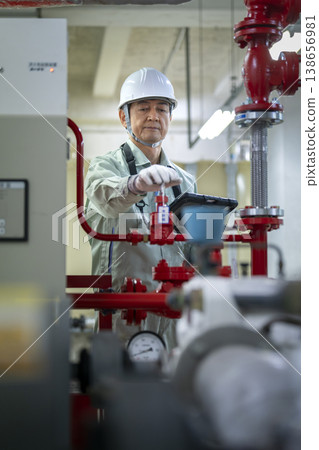 Building maintenance staff inspecting building facilities (image) 138656981