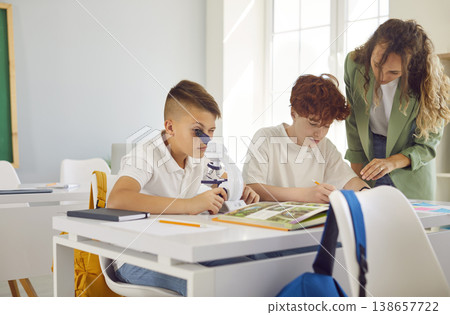 Classroom school study, pupil working with microscope discover world of science, engaging experiment Classroom school study, pupil working with microscope discover world of science, engaging experiment 138657722