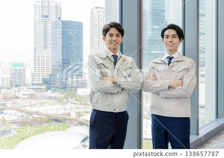 Staff in work clothes working in an office building Staff in work clothes working in an office building 138657787