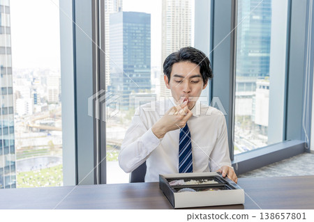 Businessmen eating lunch in a conference room Businessmen eating lunch in a conference room 138657801
