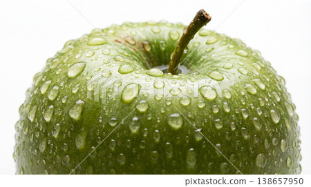 Close-up of a fresh green apple covered in water droplets with apple tree droplets hydration refreshing vitamins nutrition agriculture culinary ingredient isolated background gleaming Close-up of a fresh green apple covered in water droplets with apple tree droplets hydration refreshing vitamins nutrition agriculture culinary ingredient isolated background gleaming 138657950