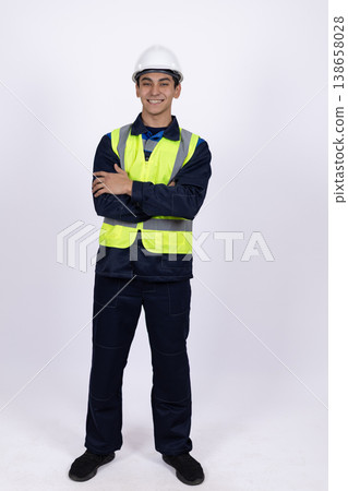 Worker in safety vest standing with crossed arms Worker in safety vest standing with crossed arms 138658028