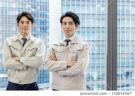 Staff in work clothes working in an office building Staff in work clothes working in an office building 138658067