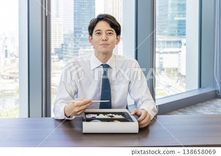 Businessmen eating lunch in a conference room 138658069