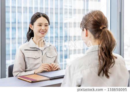 A woman in work clothes having a meeting A woman in work clothes having a meeting 138658095