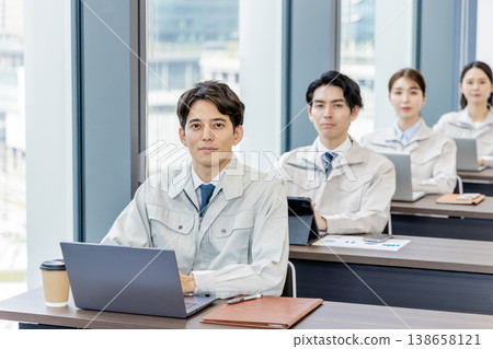 Staff in work clothes receiving training Staff in work clothes receiving training 138658121