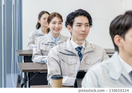 Staff in work clothes receiving training Staff in work clothes receiving training 138658124