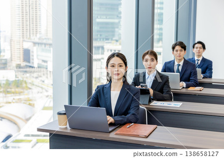 Businessmen and women participating in a seminar Businessmen and women participating in a seminar 138658127