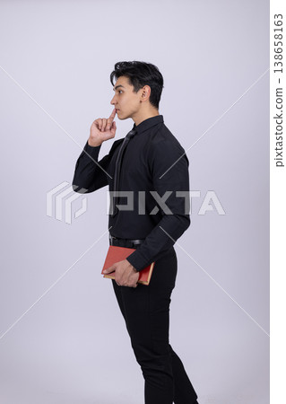 Man in black outfit looking at his watch Man in black outfit looking at his watch 138658163