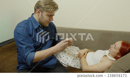 Man sitting on floor and taking care of woman in bed 138658171
