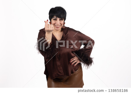 Young woman showing heart gesture with her fingers Young woman showing heart gesture with her fingers 138658186